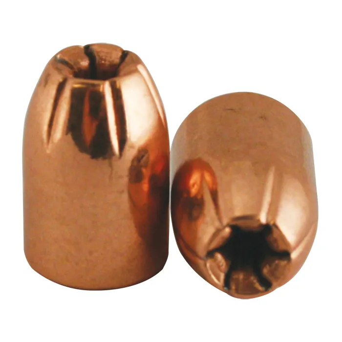 Two copper-colored hybrid hollow-point bullets, one standing upright to display the hollow cavity at its tip and the other laid on its side showing the star-shaped hollow point from the front
